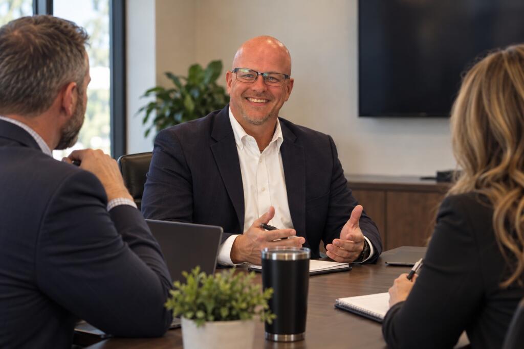 Smiling businessman leading a meeting at a conference table
